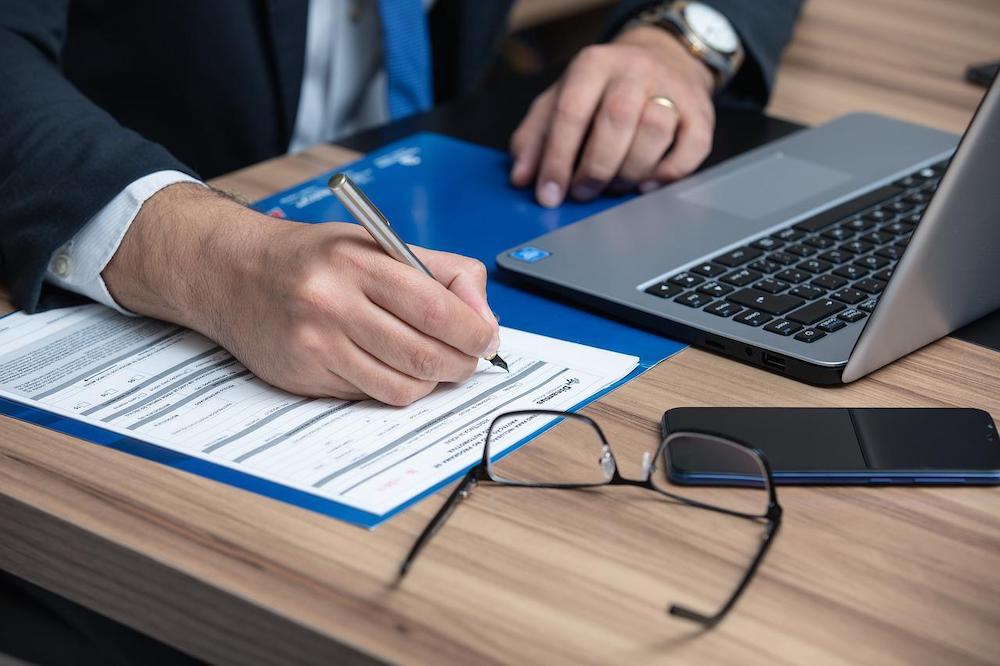 person signing a document